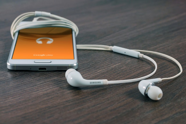 Image of earbuds listening to podcast